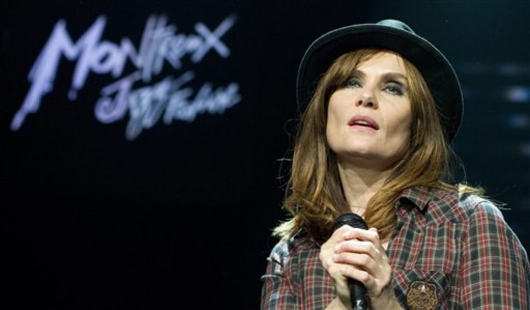 French actress and singer Emmanuelle Seigner, wife of Director Roman Polanski, performs on the Stravinski Hall stage at the 44th Montreux Jazz Festival, in Montreux, Switzerland, Saturday, July 17, 2010. Film director Roman Polanski, watched his wife Emmanuelle Seigner, perform Saturday, in the first public appearance for since the Oscar-winning director was freed earlier this month from house arrest when the Swiss government refused to deport him to the United States, on charges relating to a 1977 child sex case. (AP Photo / KEYSTONE, Martial Trezzini)